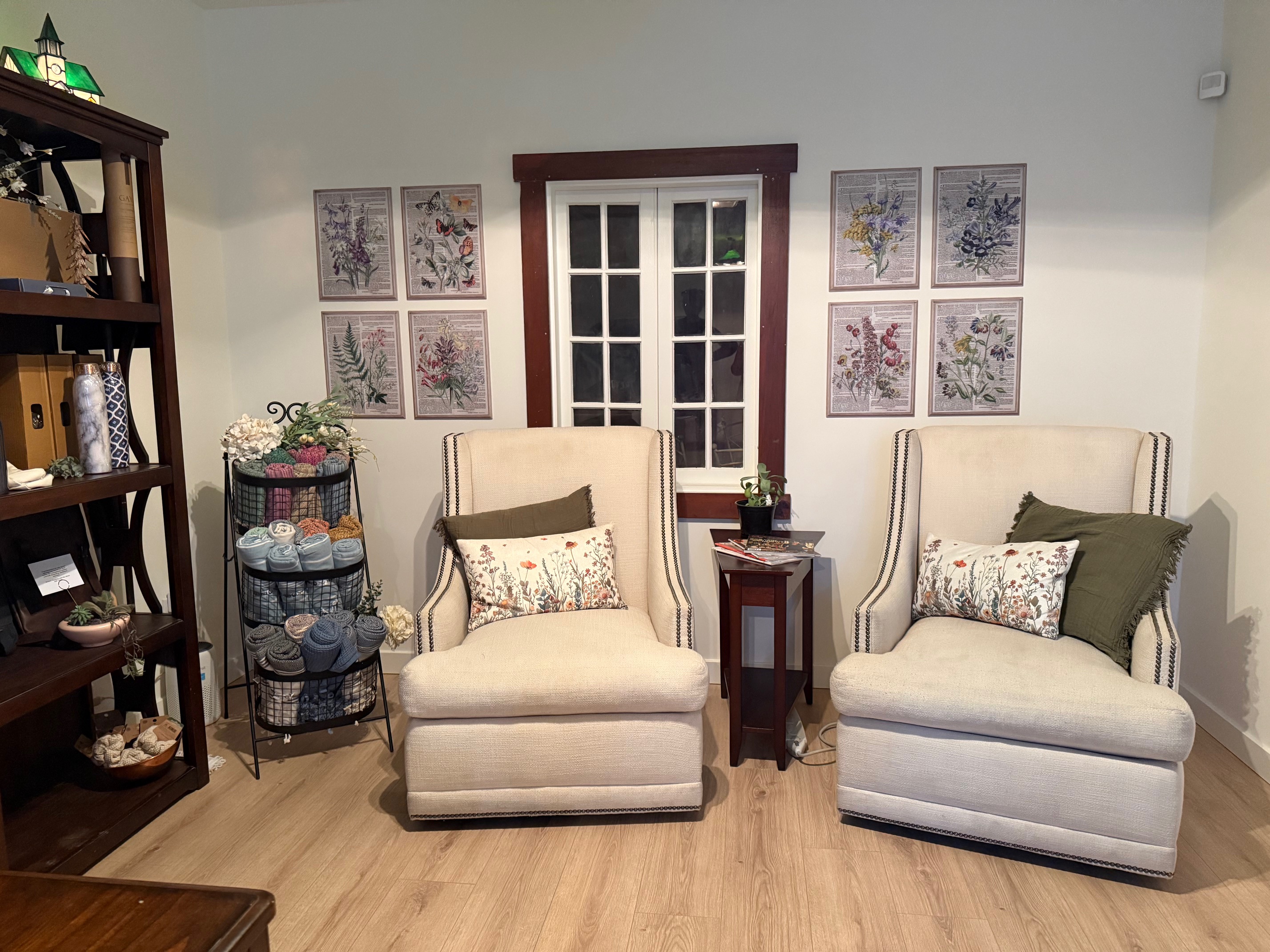The welcoming interior of Organically Whole cottage with botanical prints and warm wood floors